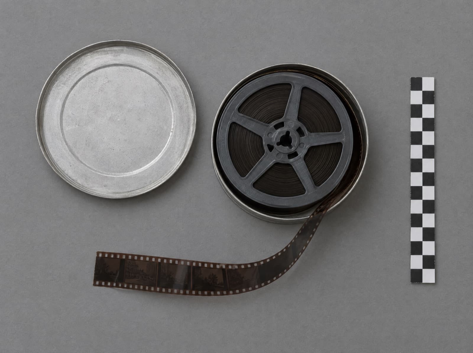 A reel of archival film in an open aluminium canister