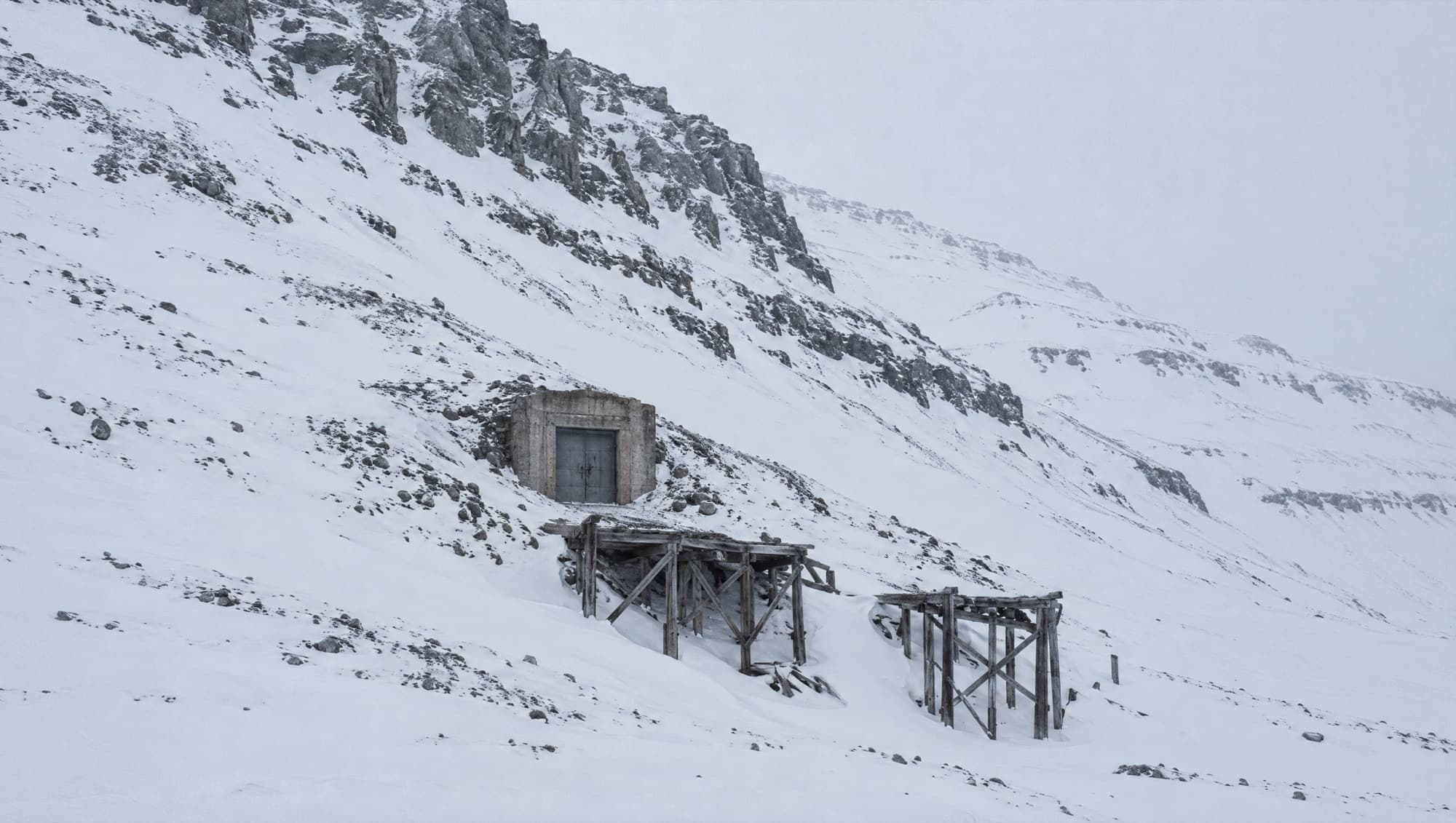 A mine entrance in a snow-covered Arctic mountainside